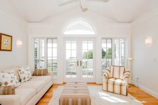 a spacious bedroom with a bed and glass window