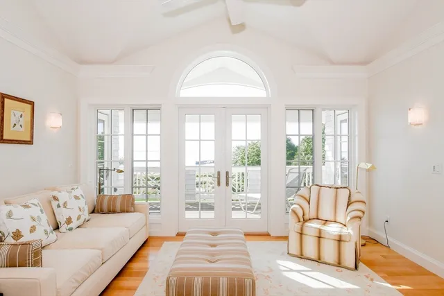a spacious bedroom with a bed and glass window