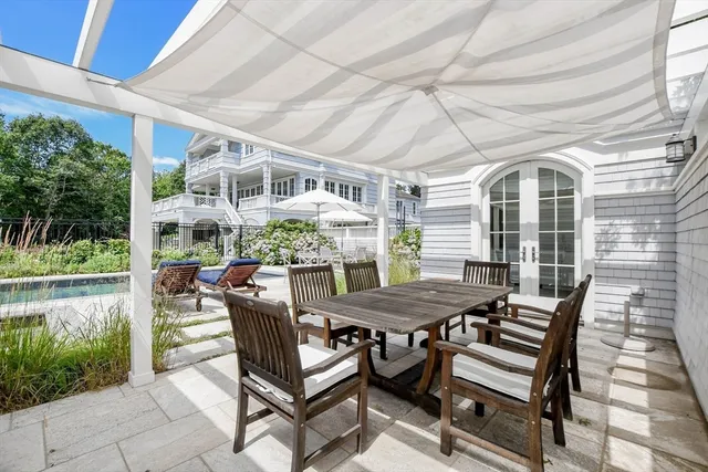 a view of a patio with a table and chairs