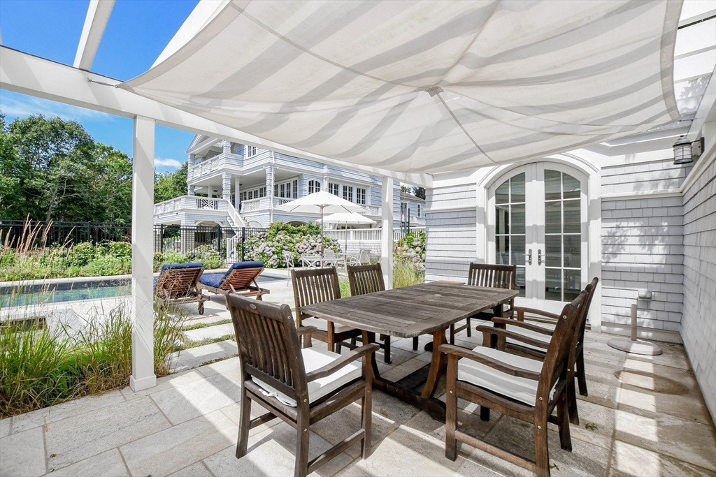 85 Moorings Road Marion, MA 02738 - Photo 27 of 37 a view of a patio with a table and chairs