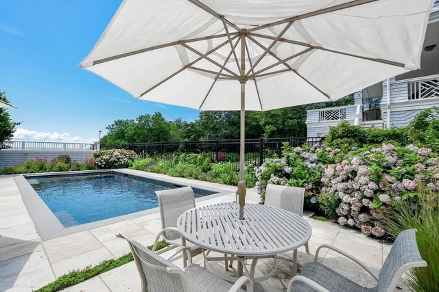 a view of patio with furniture and umbrella