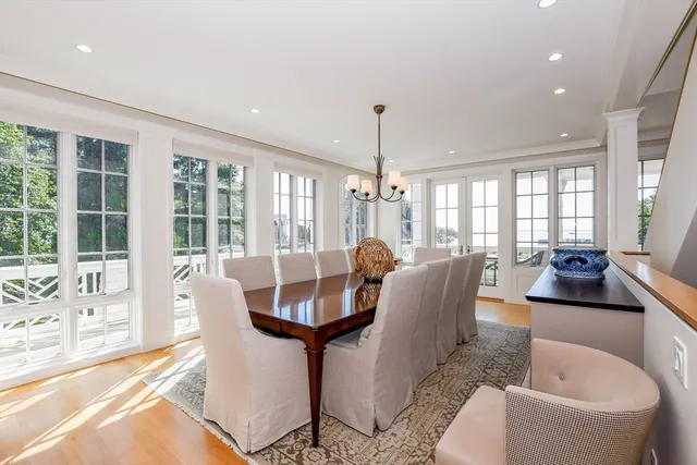 a view of a dining room with furniture a chandelier and wooden floor