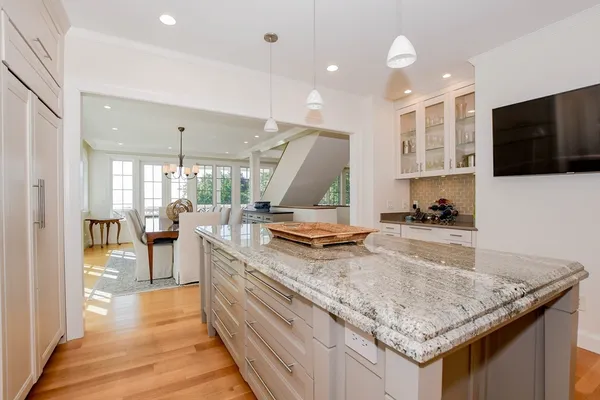 a kitchen with stainless steel appliances granite countertop sink stove top oven and cabinets