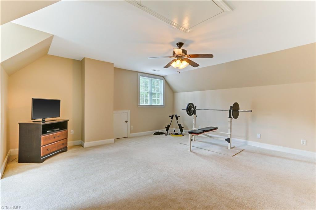 6703 Fegan Road Summerfield, NC 27358 - Photo 22 of 30 3rd Floor Bonus space. Wall to Wall carpeting. Pull down stair access to partially floored attic storage.