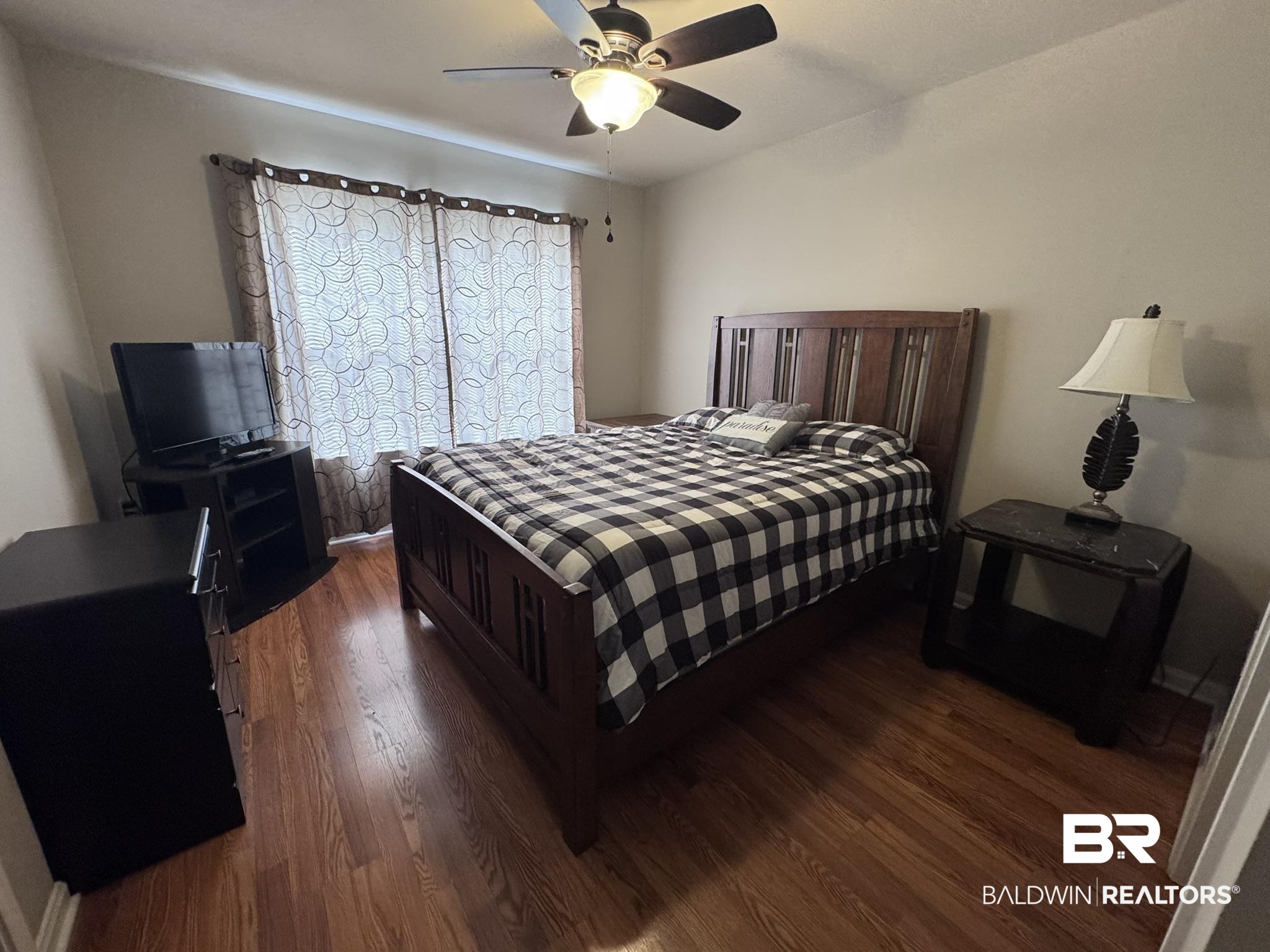 1517 Regency Road, Unit 131 Gulf Shores, AL 36542 - Photo 11 of 21 Bedroom featuring dark wood-style flooring and ceiling fan