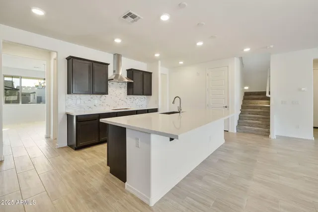 a large kitchen with stainless steel appliances kitchen island granite countertop a large counter top and oven