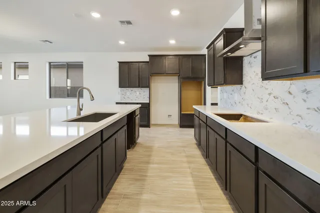 a large kitchen with stainless steel appliances sink a microwave and cabinets