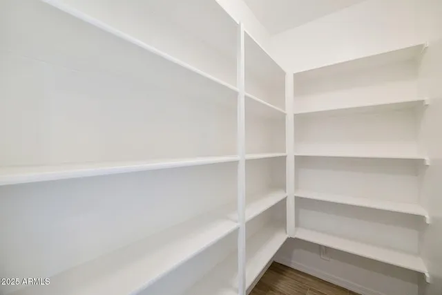a view of a kitchen with a sink and dishwasher a refrigerator with wooden floor