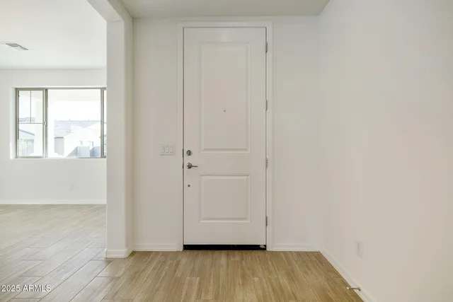 a view of wooden floor and windows in a room
