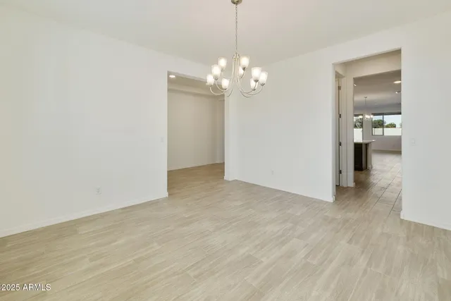 a view of a chandelier in big room and a bathroom