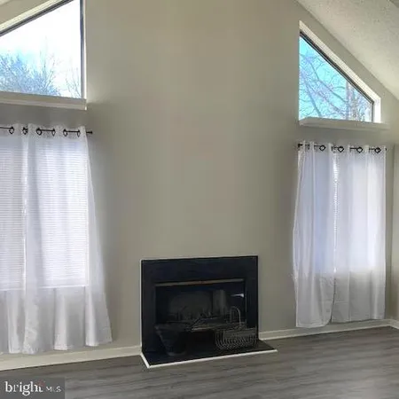 a living room with a fireplace and a window