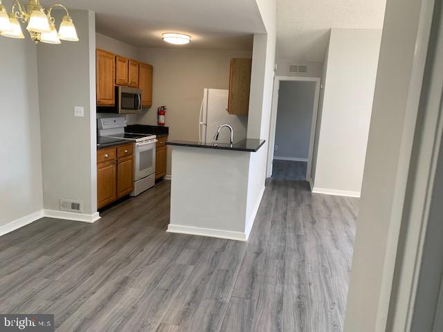 805 Augusta Circle Mount Laurel, NJ 08054 - Photo 6 of 24 a kitchen with a refrigerator and a stove top oven