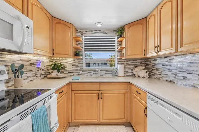 a kitchen with appliances cabinets and a sink