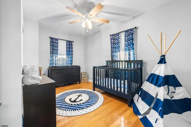 a bedroom with two beds and painting on the wall