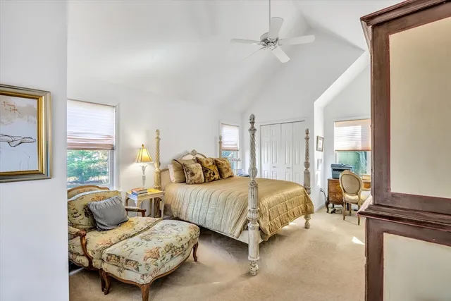 a bed room with a bed window and a mirror