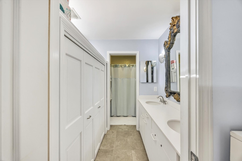 4 Bob White Crescent, Unit 4 Mashpee, MA 02649 - Photo 23 of 37 a bathroom with a double vanity sink and mirror