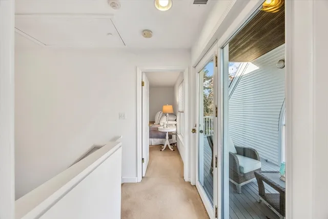 a view of hallway with wooden floor