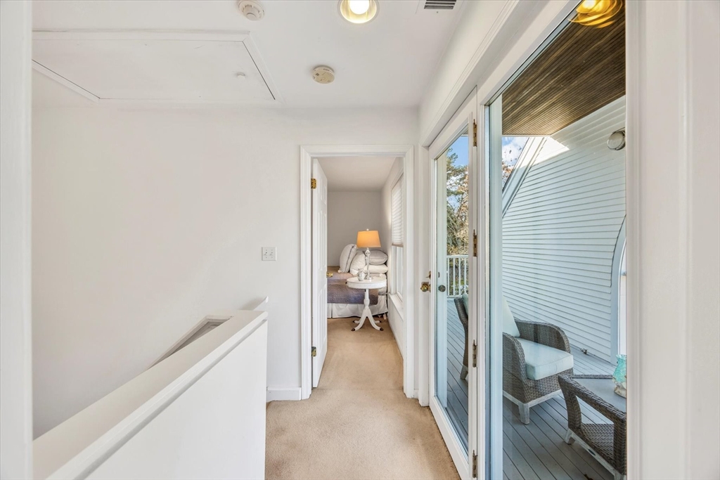 4 Bob White Crescent, Unit 4 Mashpee, MA 02649 - Photo 26 of 37 a view of a hallway with wooden shelves