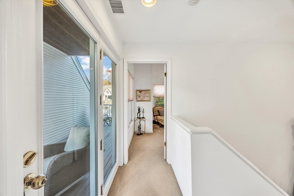 4 Bob White Crescent, Unit 4 Mashpee, MA 02649 - Photo 27 of 37 a view of hallway with wooden floor