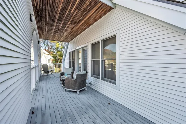 a balcony with furniture and wooden floor