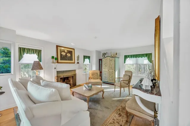 a living room with furniture a fireplace and a window