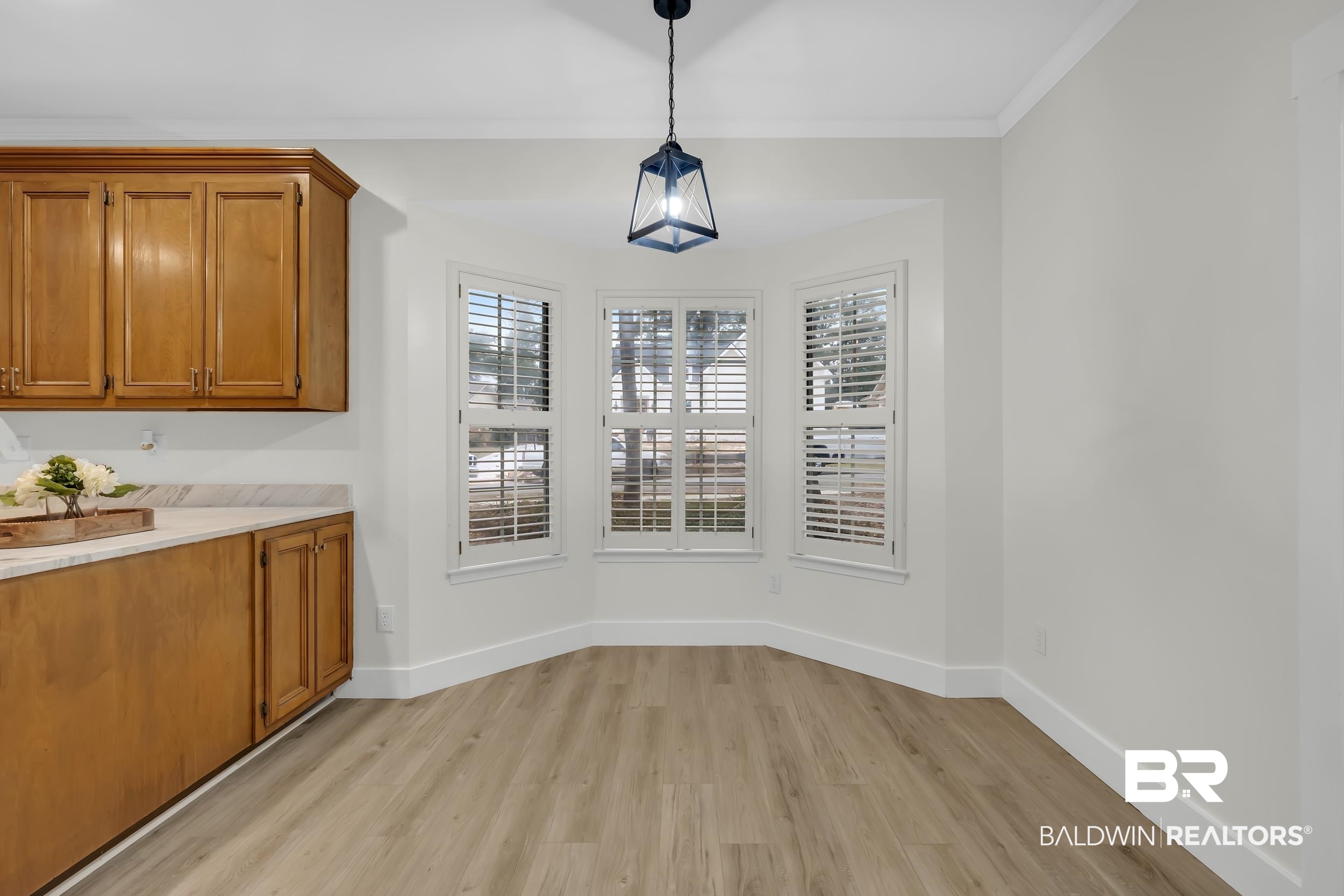 4924 Brooke Court Mobile, AL 36618 - Photo 18 of 34 Unfurnished dining area with baseboards and light wood-style floors