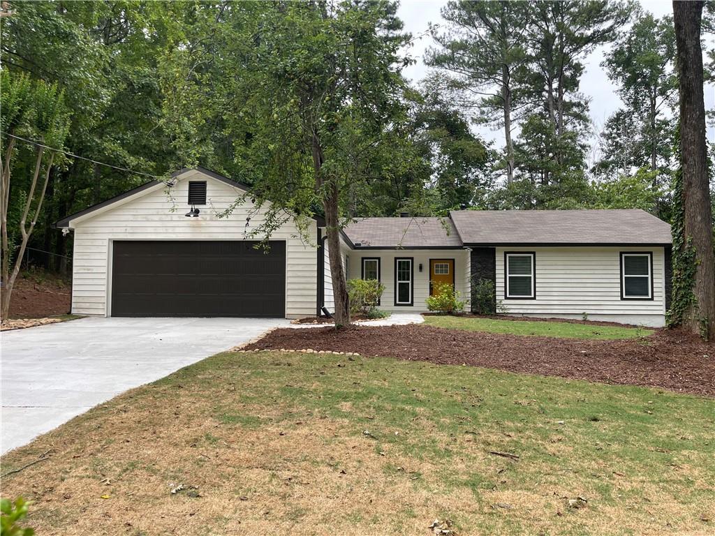 a front view of a house with a garden