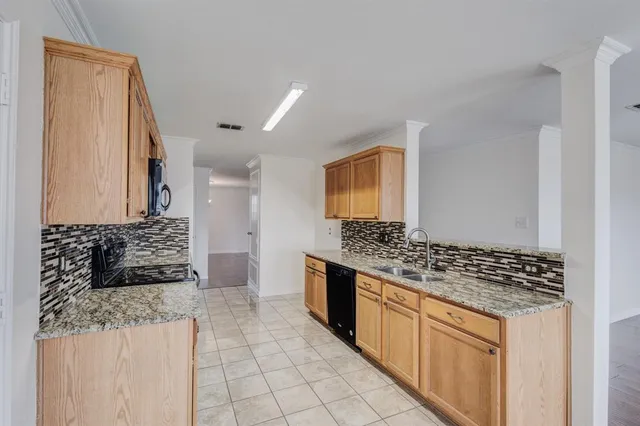 a view of a kitchen with a sink and a stove top oven