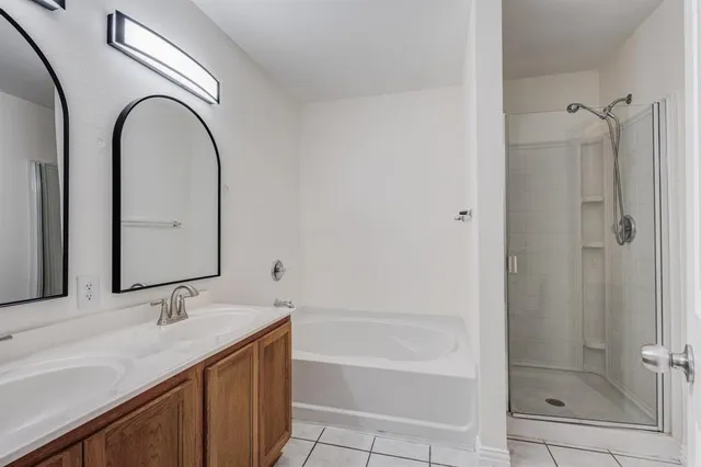 a bathroom with 2 sink and a bathtub