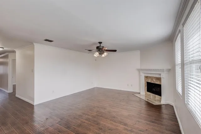 wooden floor in an empty room with a window