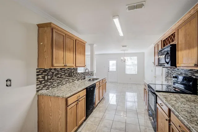 a kitchen with stainless steel appliances granite countertop a sink stove and cabinets