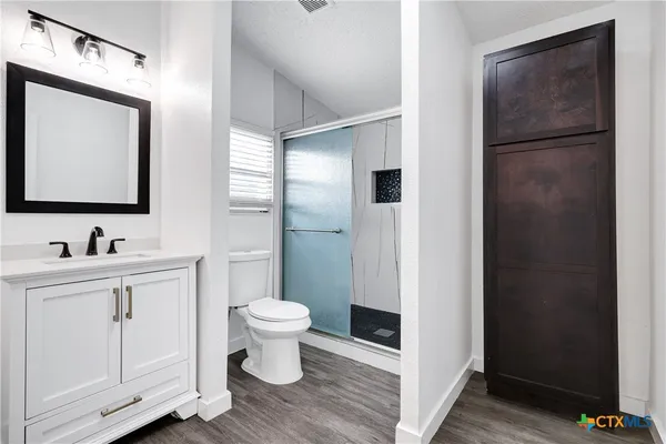 a bathroom with a toilet sink and mirror