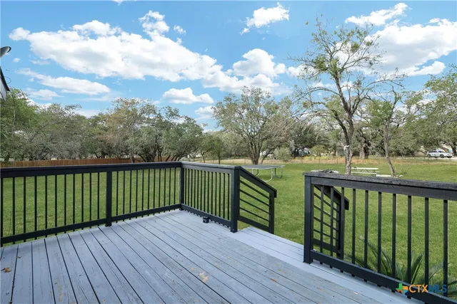 a view of balcony with wooden floor and fence