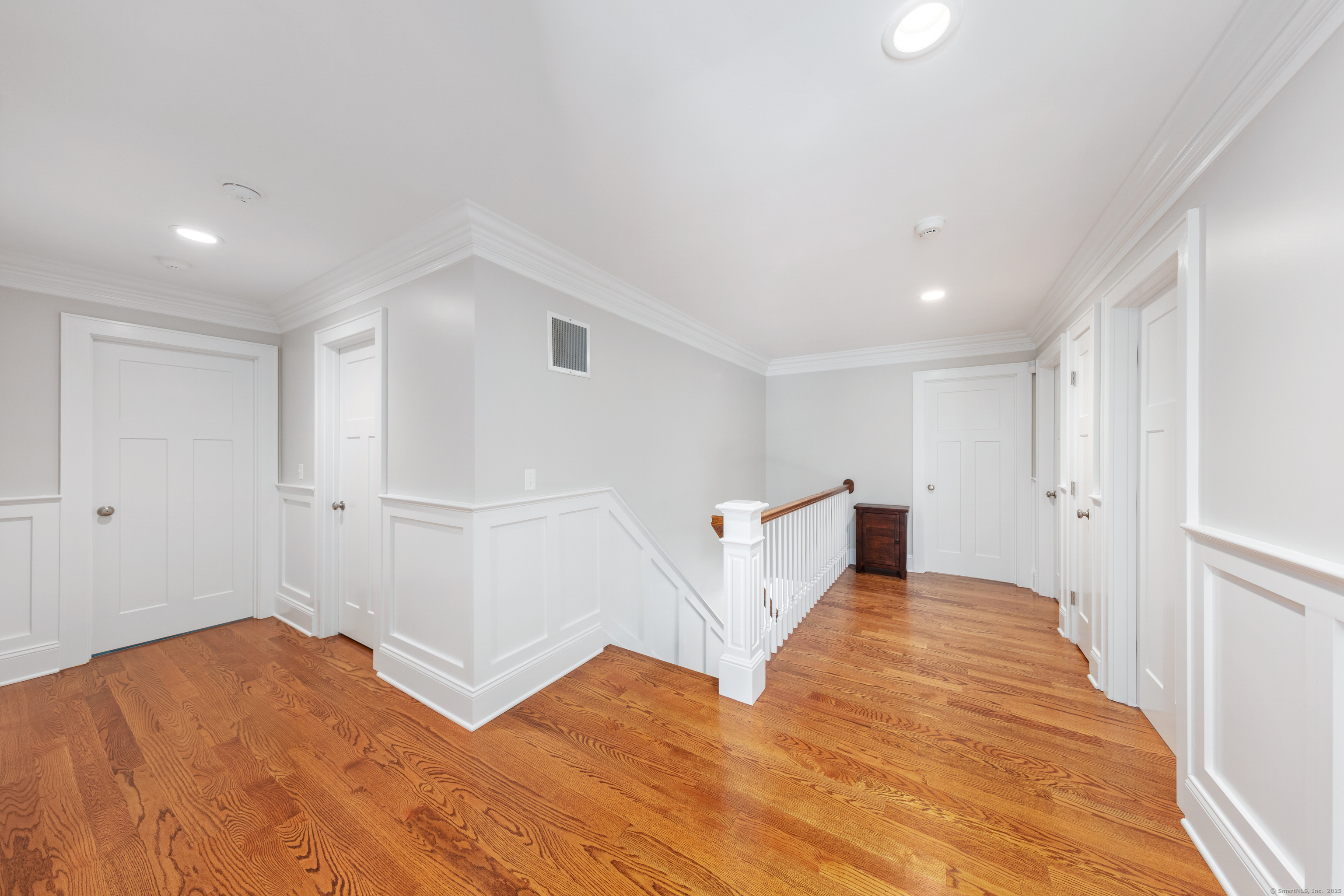 109 Jeniford Road Fairfield, CT 06824 - Photo 15 of 40 a view of a bedroom with wooden floor and white walls