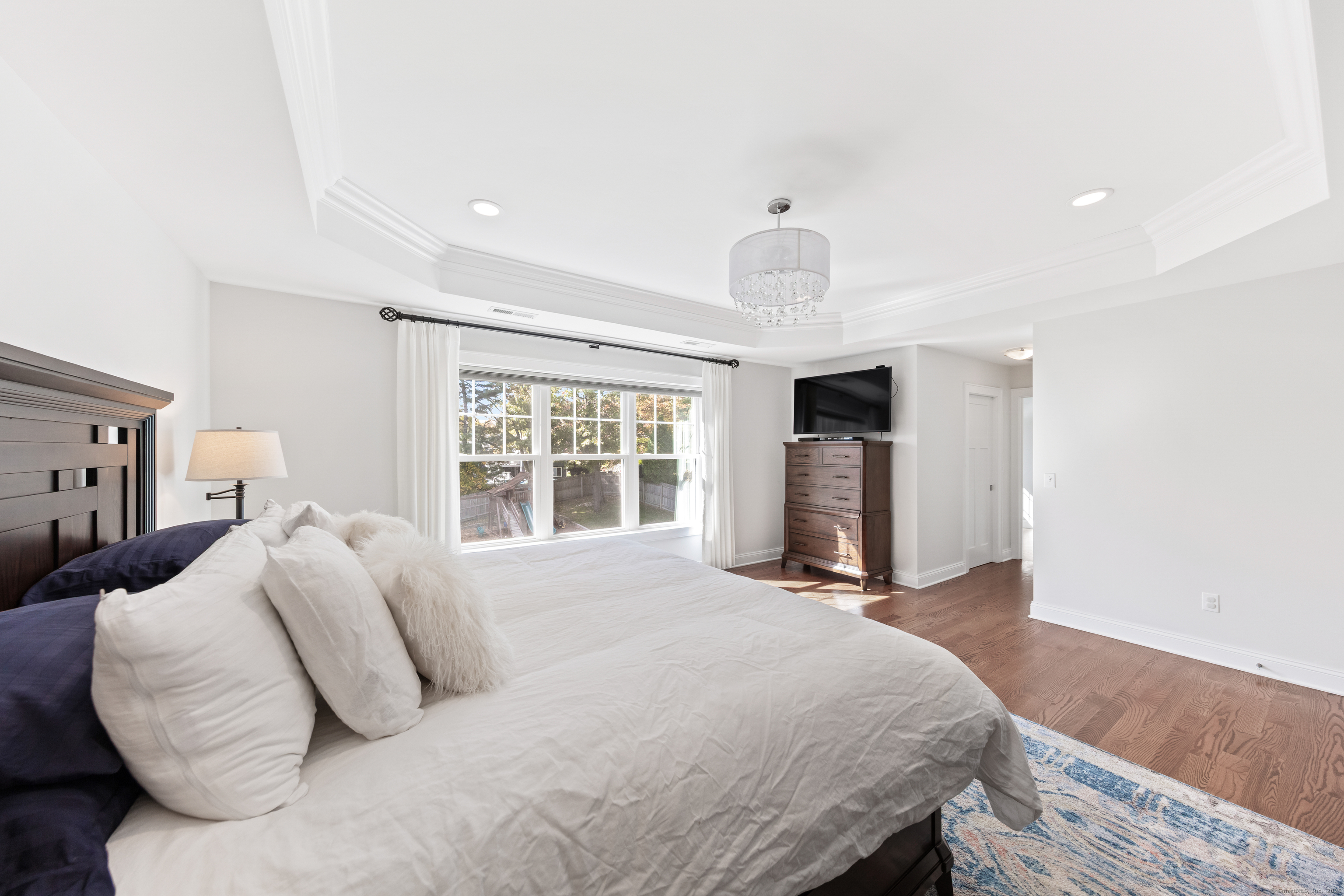 109 Jeniford Road Fairfield, CT 06824 - Photo 18 of 40 a bedroom with a bed and a fireplace