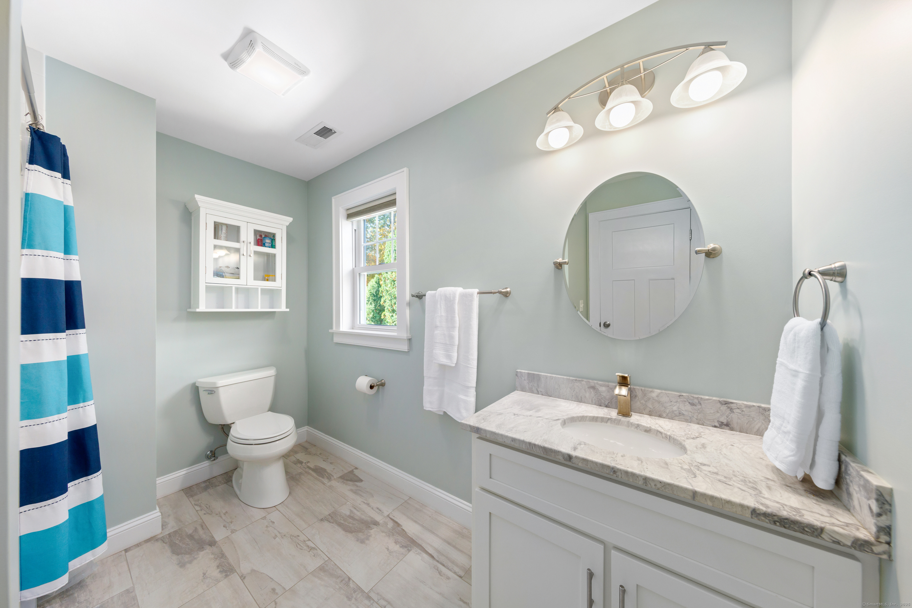 109 Jeniford Road Fairfield, CT 06824 - Photo 23 of 40 a bathroom with a double vanity sink and a mirror