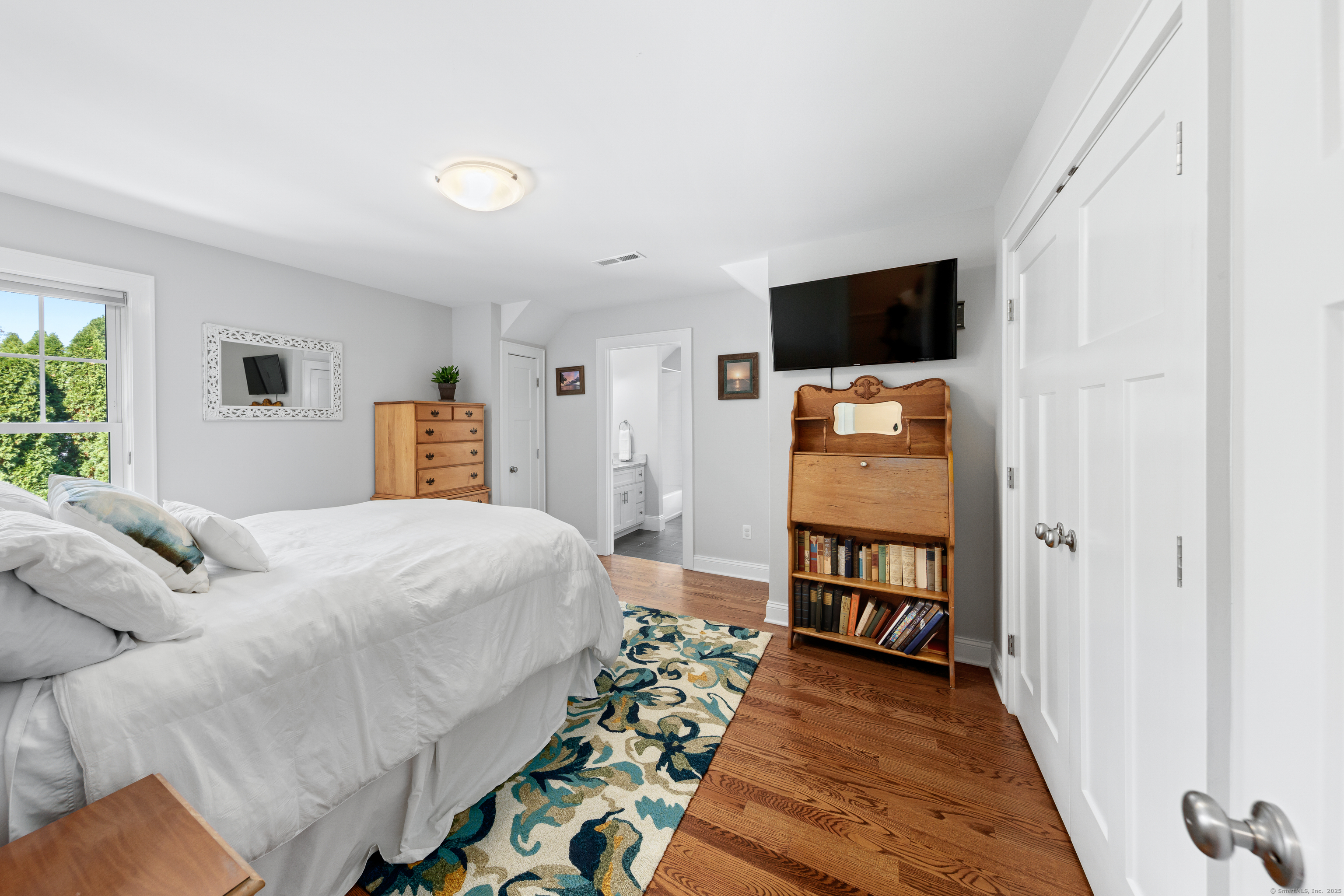 109 Jeniford Road Fairfield, CT 06824 - Photo 25 of 40 a bedroom with a bed and a flat screen tv