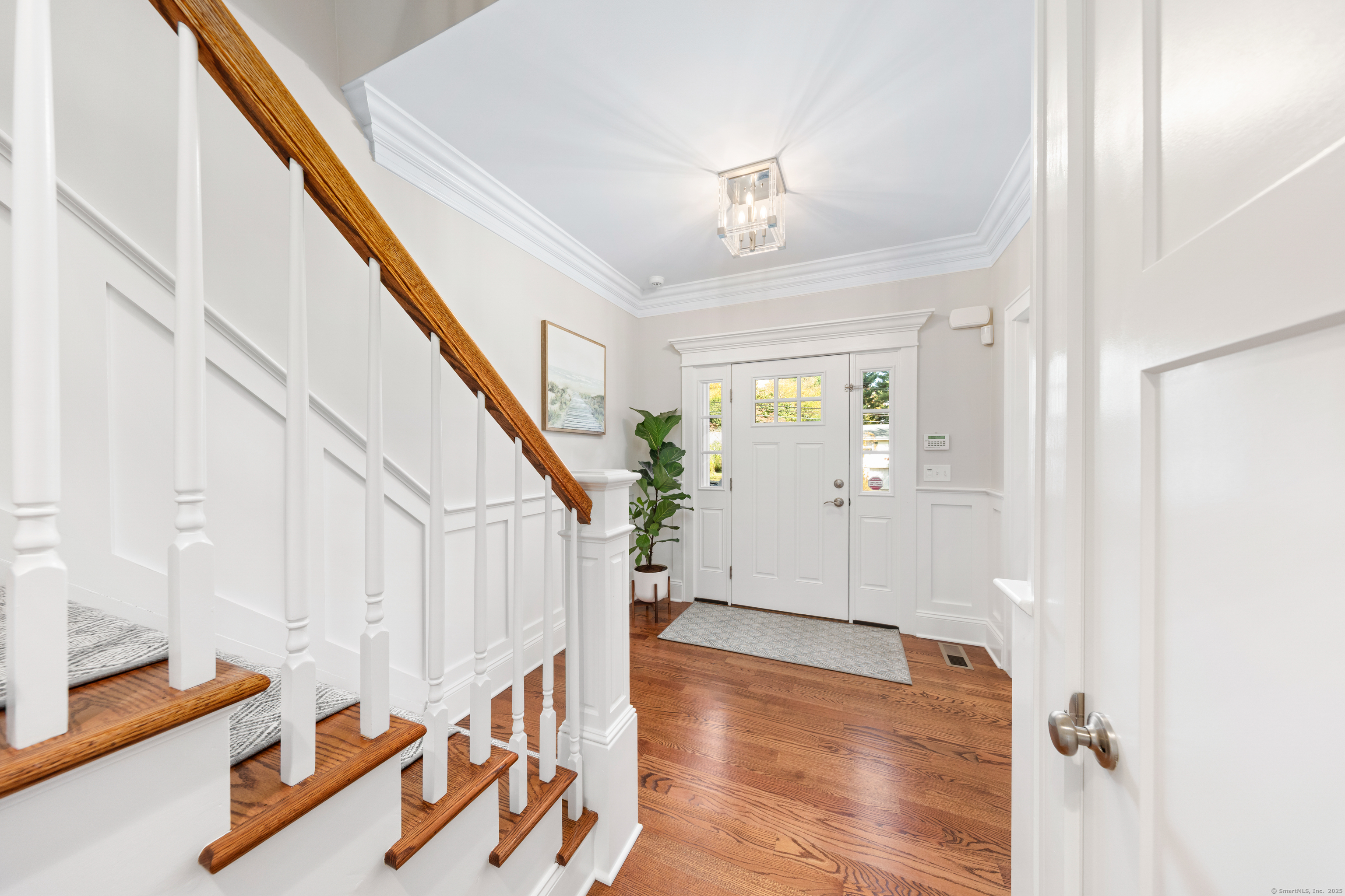 109 Jeniford Road Fairfield, CT 06824 - Photo 3 of 40 a view of an entryway with wooden floor and stairs