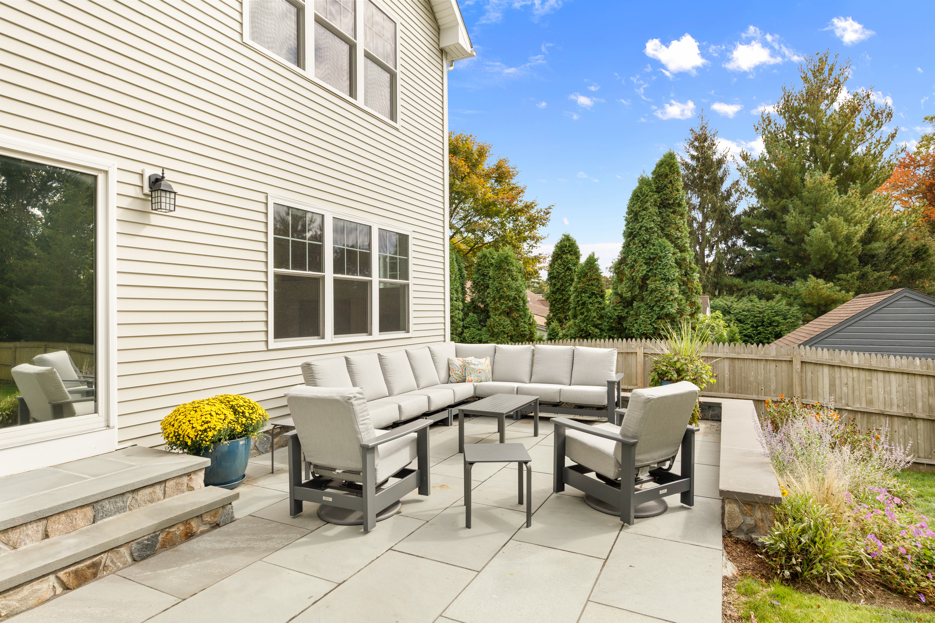 109 Jeniford Road Fairfield, CT 06824 - Photo 31 of 40 a view of a patio with a table and chairs and potted plants