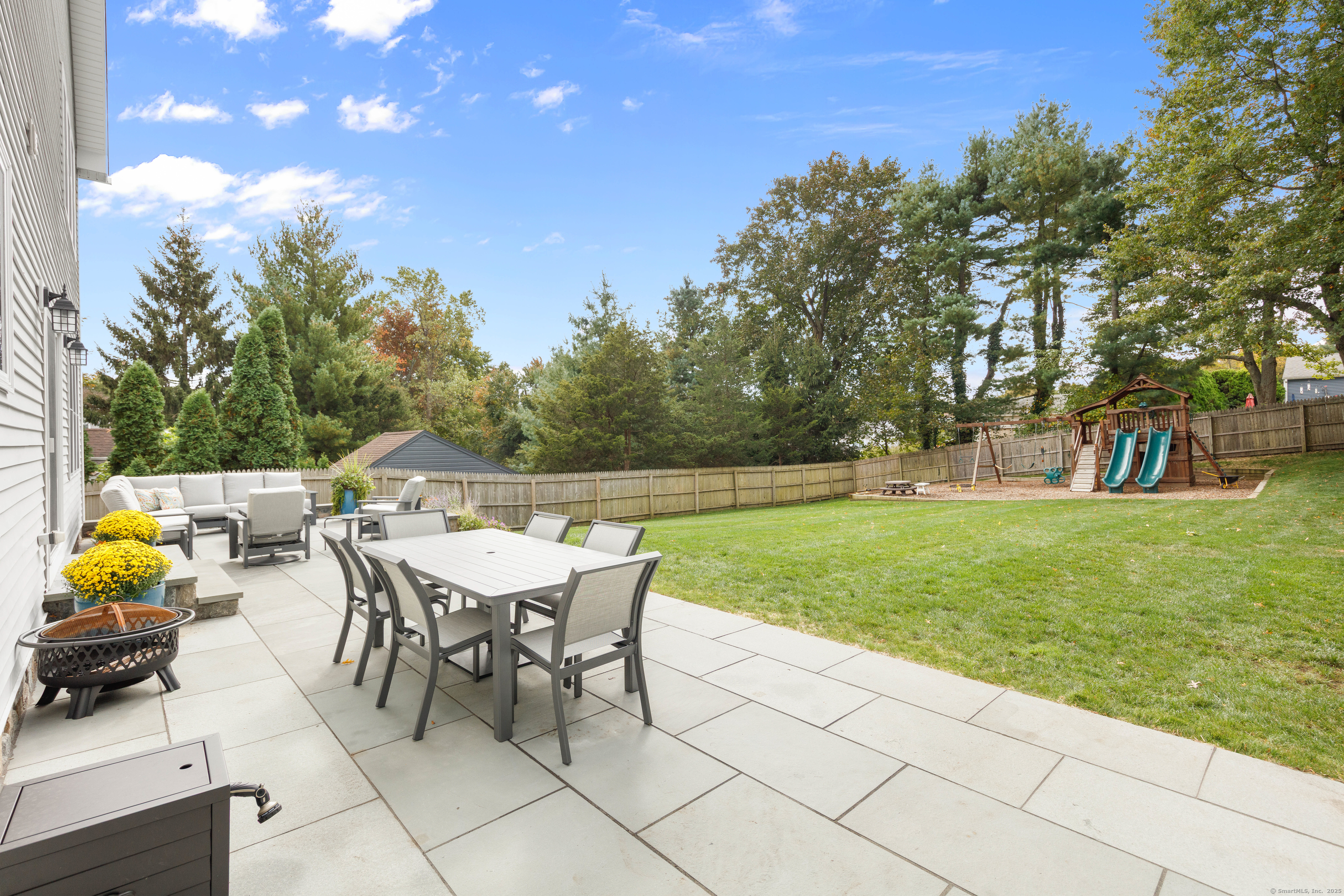 109 Jeniford Road Fairfield, CT 06824 - Photo 32 of 40 a view of a dining table and chairs in the garden