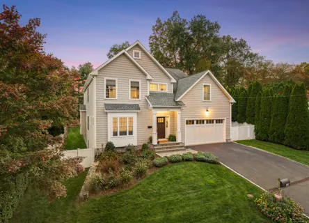a view of a big house with a big yard and large trees