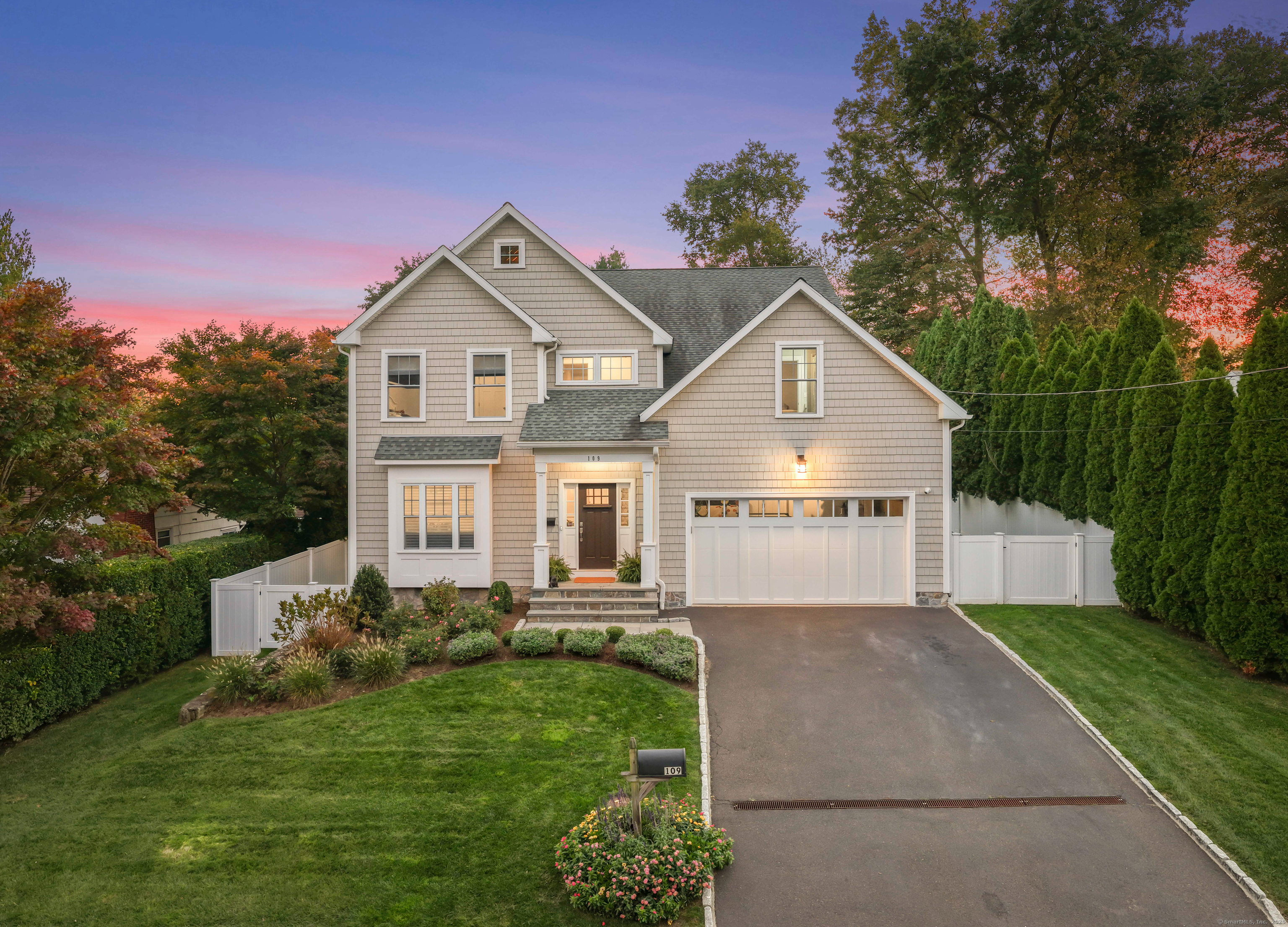 109 Jeniford Road Fairfield, CT 06824 - Photo 38 of 40 a front view of a house with a yard and garage