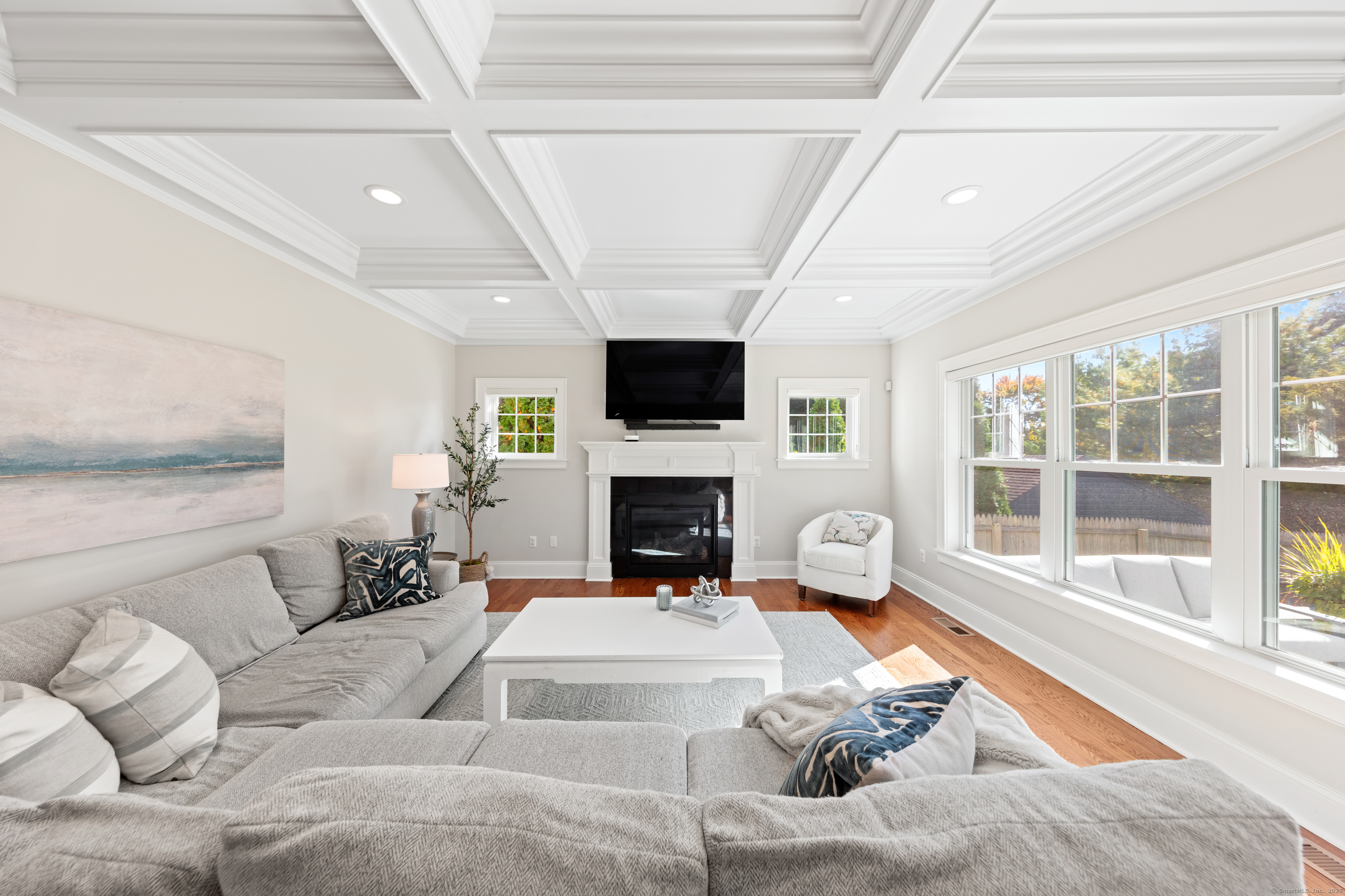 109 Jeniford Road Fairfield, CT 06824 - Photo 4 of 40 a living room with furniture a fireplace and a flat screen tv
