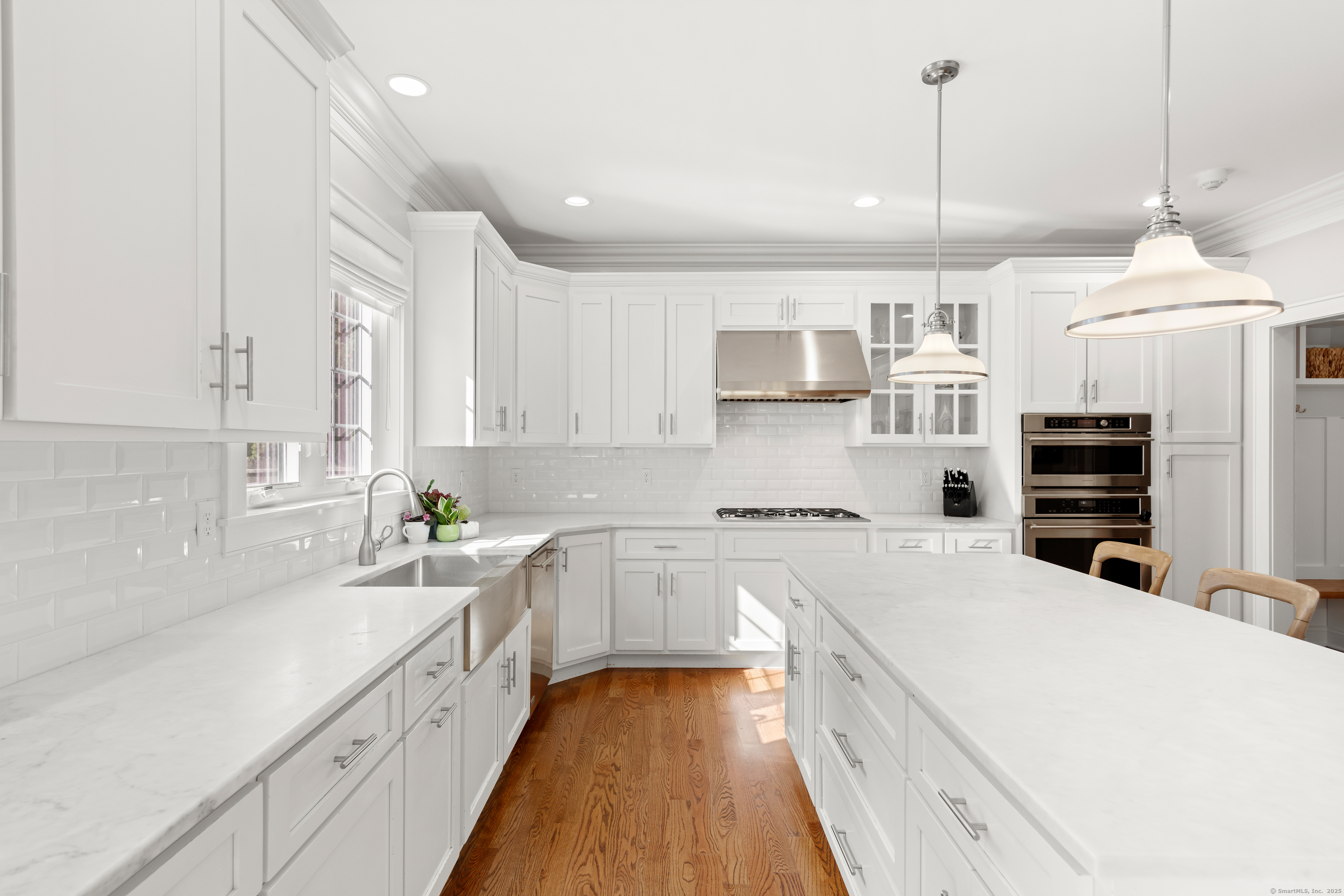 109 Jeniford Road Fairfield, CT 06824 - Photo 9 of 40 a large kitchen with granite countertop a lot of counter space and wooden floor