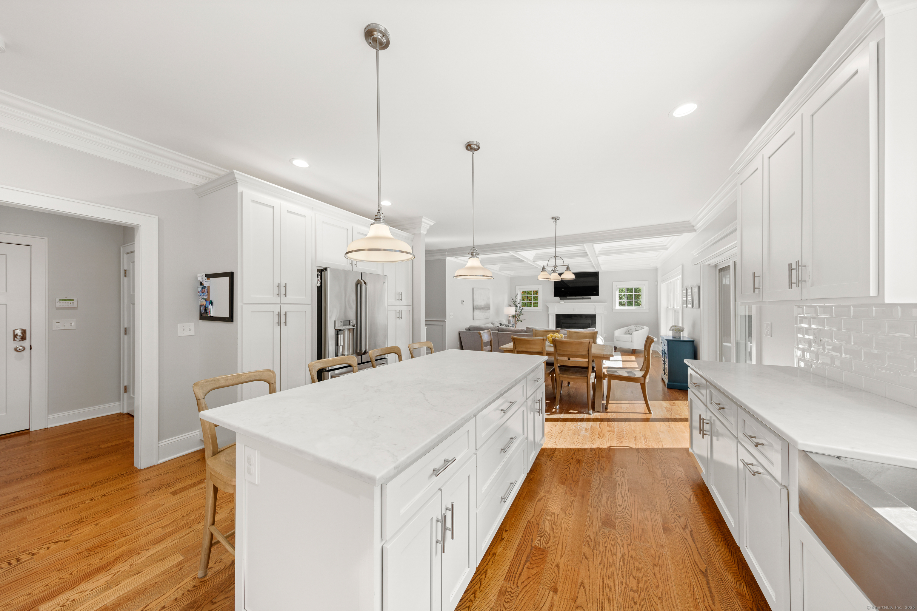 109 Jeniford Road Fairfield, CT 06824 - Photo 10 of 40 a large kitchen with kitchen island a white counter space a sink appliances and cabinets