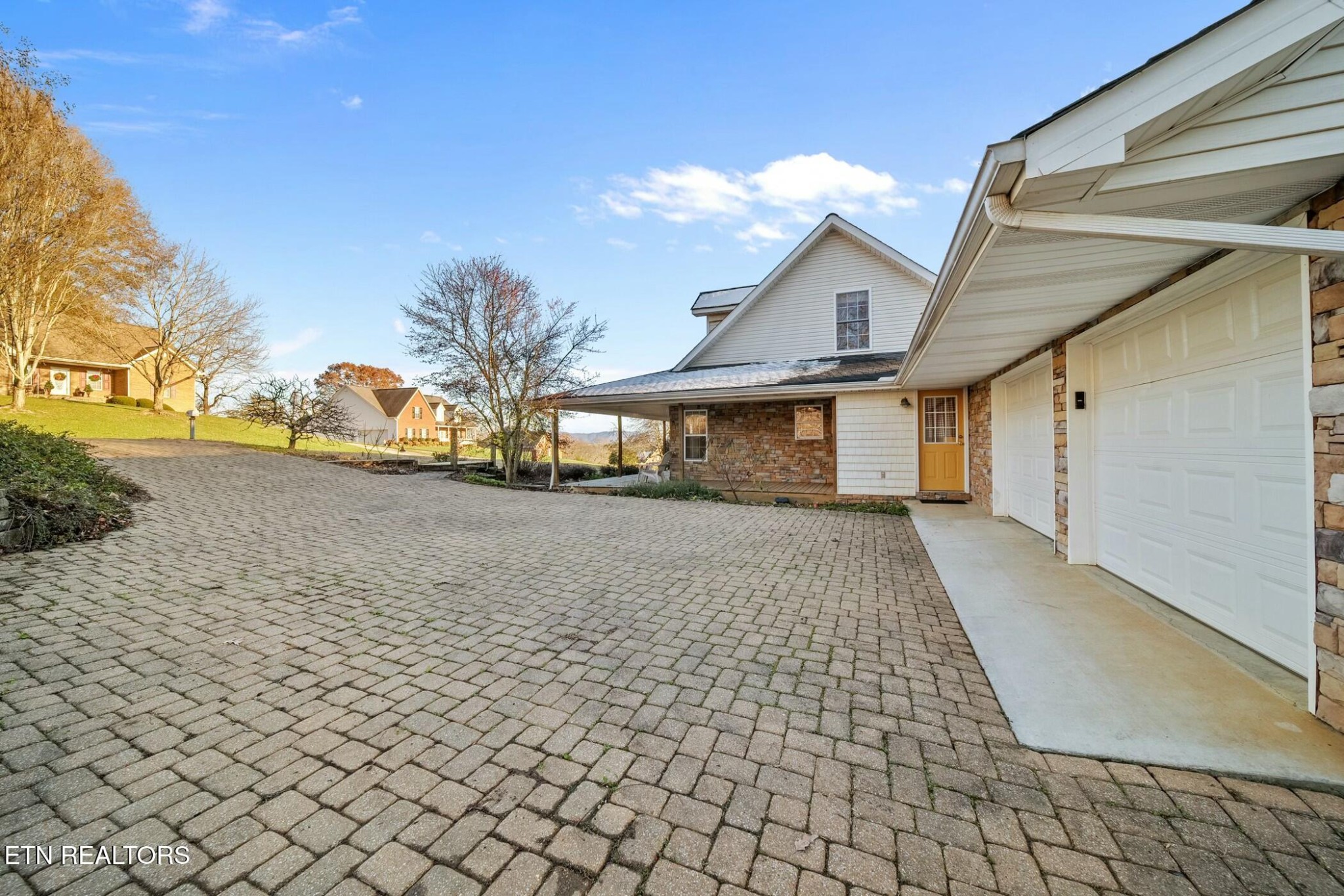 8345 Cliff Ridge Court Corryton, TN 37721 - Photo 44 of 54 a view of a white house with a yard and potted plants