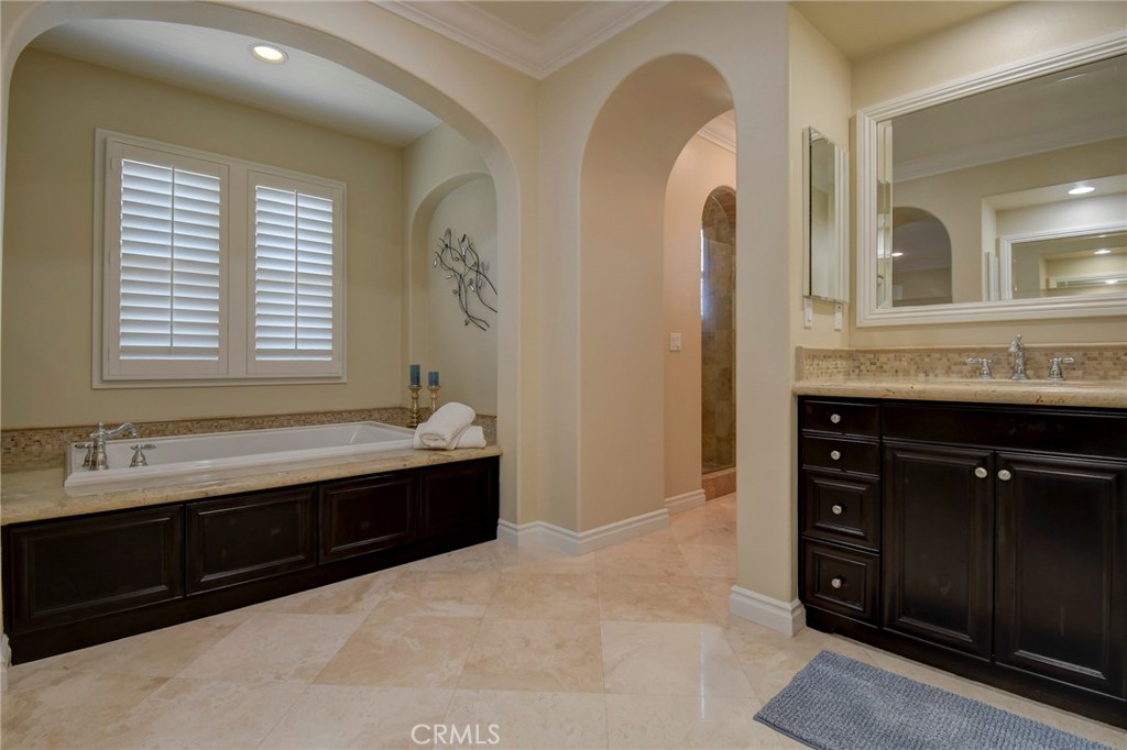 62 Gentry Irvine, CA 92620 - Photo 18 of 48 a spacious bathroom with a granite countertop sink a mirror and a bathtub