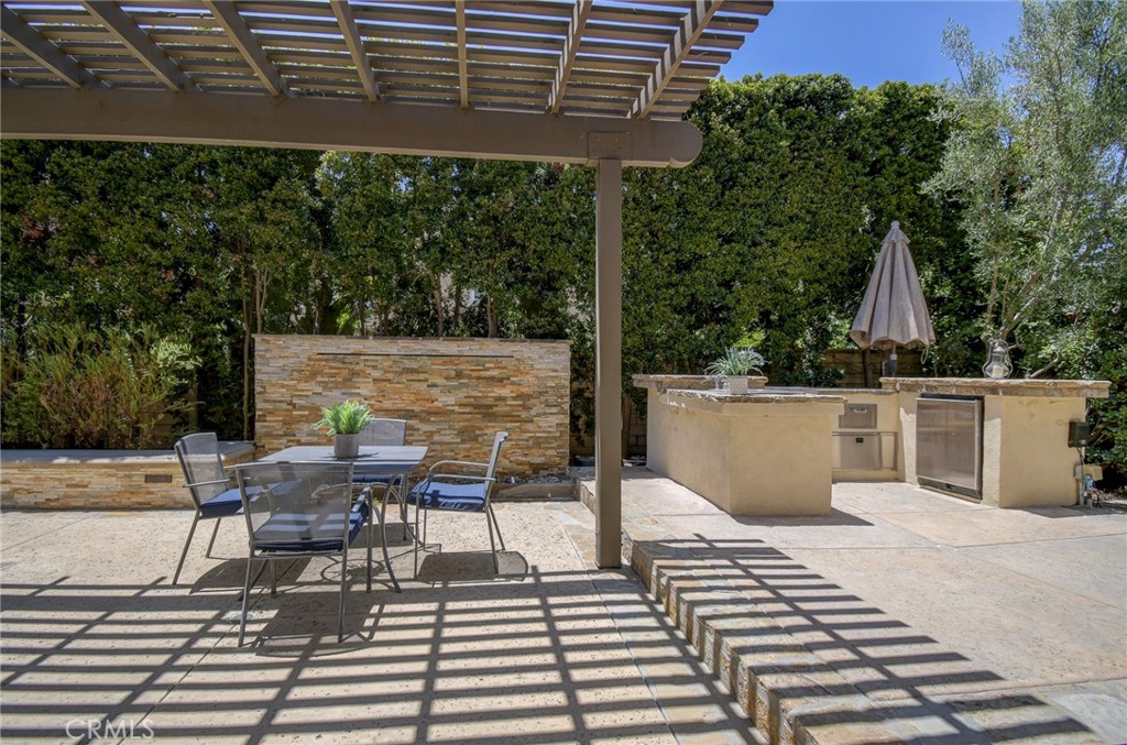 62 Gentry Irvine, CA 92620 - Photo 28 of 48 a view of a patio with table and chairs and potted plants