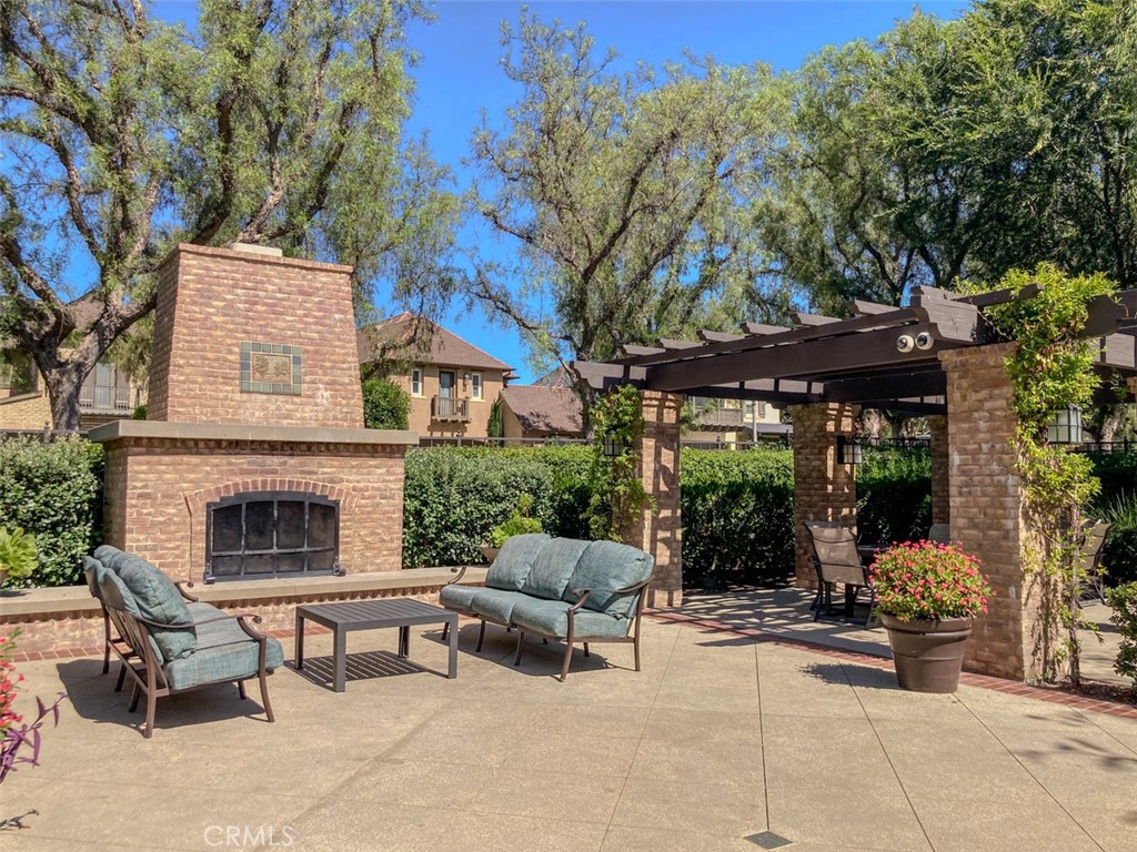 62 Gentry Irvine, CA 92620 - Photo 33 of 48 a patio with a table and chairs and a fire pit