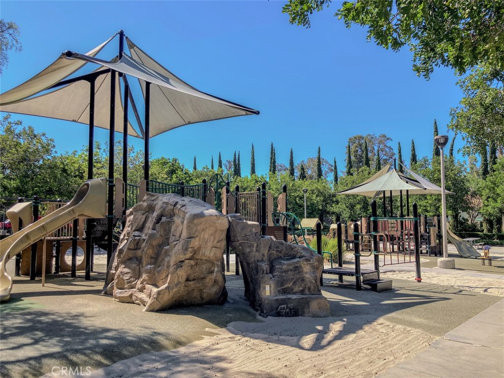 62 Gentry Irvine, CA 92620 - Photo 44 of 48 a view of a patio with a table and chairs under an umbrella